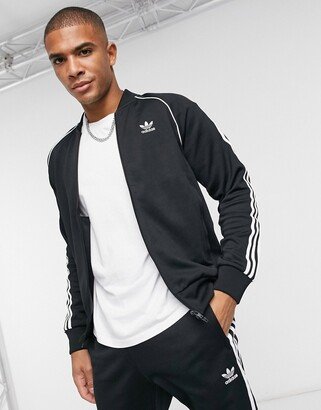 Superstar three stripe track jacket in black