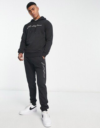 script logo tracksuit set in black