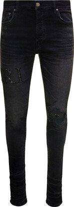 Black Skinny Jeans With Crystal Embellished Logo And Used Effect In Stretch Cotton Denim Man