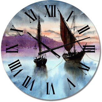 Designart 'Sailing Boats In The Sea In Evening With City' Nautical & Coastal wall clock