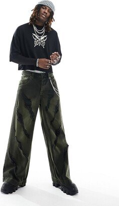 extreme wide leg jeans with grunge rips in green tinted wash