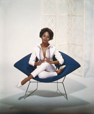 Young Woman Sitting on Armchair from Getty Images