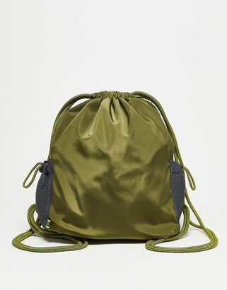 Basic Pleasure Mode drawstring backpack in khaki with black mesh side pockets