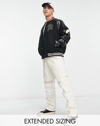 oversized varsity jacket in black with faux leather sleeves