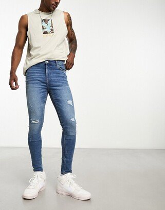 spray on jeans with power stretch in mid wash blue