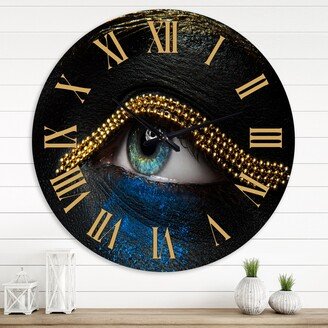 Designart 'Female Eyes With Black Skin With A Gold Chain' Modern wall clock