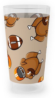 Outdoor Pint Glasses: Football Turkey With Helmet And Football - Orange On Tan Outdoor Pint Glass, Beige