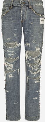 Washed denim jeans with studs and rips