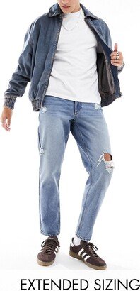 classic rigid jeans with rips in mid wash blue