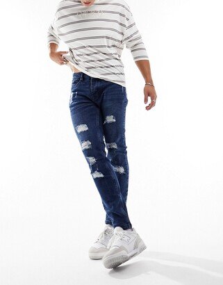 skinny fit multi rip jeans in mid blue