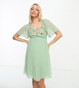 ASOS DESIGN Maternity tie back angel sleeve pleated mini dress with embroidered bust in sage green