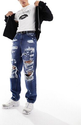 baggy jeans with extreme rips in dark wash blue