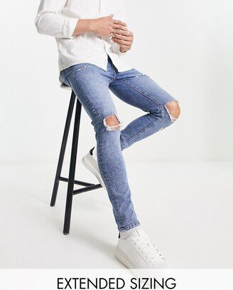 spray on jeans with power stretch in mid wash with knee rips and abrasions