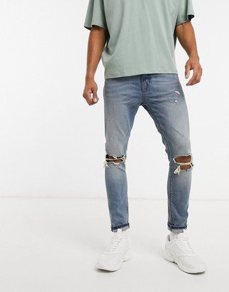 cropped super skinny jeans in mid blue with knee rips