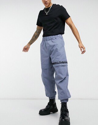 ASOS Unrvlld Spply pants in oversized tapered fit in blue